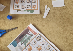 Dzieci przy stoliku rozwiązują leśne sudoku.