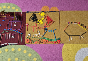 "Świat dinozaurów" na dywanikach wykonany z darów zabawy Froebla.