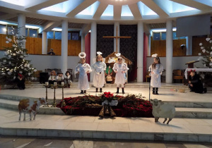 dzieci przedstawiają Jasełka Bożonarodzeniowe w kościele
