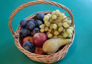 Na stoliku stoi kosz z owocami