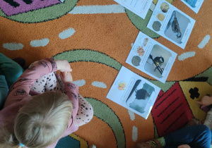 Dzieci oglądają ilustrację z ptakami.